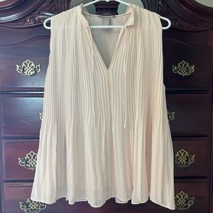 Flowy sleeveless shirt with neck detail, can dress up or down